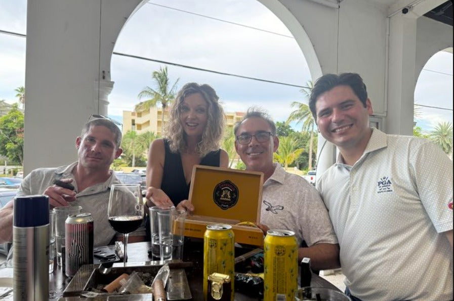 Cigar enthusiasts at the Hispaniola Cigars Brand Event at Polo Steak and Sea (formerly Polo Grill) in Vero Beach, Florida, with an open box of Empereur Jacques 1er cigars